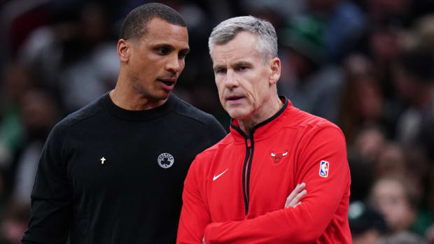 Celtics coach Joe Mazzulla talks with Bulls coach Billy Donovan from the sideline at TD Garden.