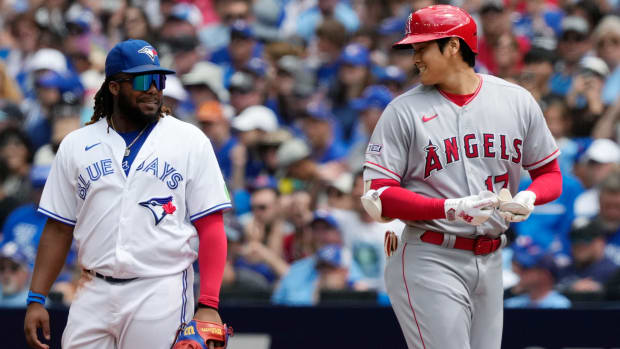 Angels designated hitter Shohei Ohtani (right) talks to Blue Jays first baseman Vladimir Guerrero Jr.