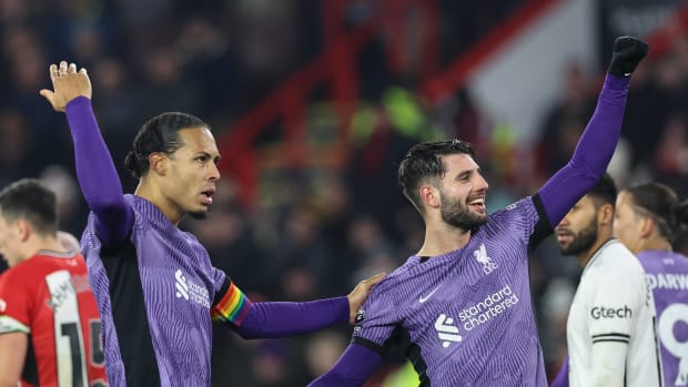 Virgil van Dijk (left) and Dominik Szoboszlai (right) pictured celebrating a goal during Liverpool's 2-0 win at Sheffield United in December 2023