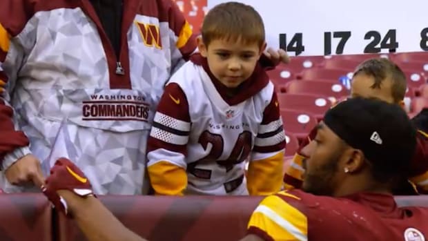 Antonio Gibson shares a moment with a young Commanders fan.