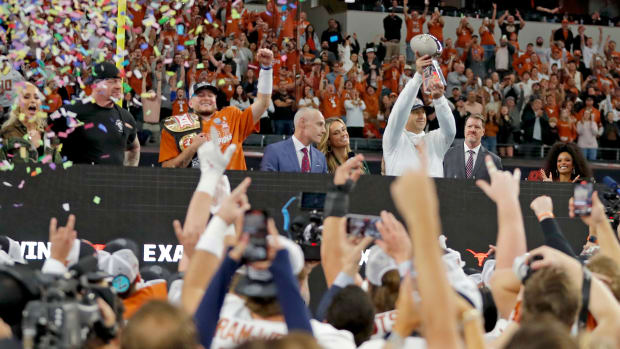 Texas head football coach Steve Sarkisian holds up the Big 12 Football Championship trophy following the Oklahoma State University Cowboys and the Texas Longhorns at the AT&T Stadium in Arlington, Texas, Saturday, Dec. 2, 2023.