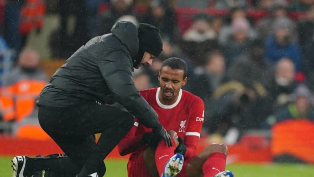 Joel Matip pictured receiving treatment for a knee injury during Liverpool's 4-3 win over Fulham in December 2023