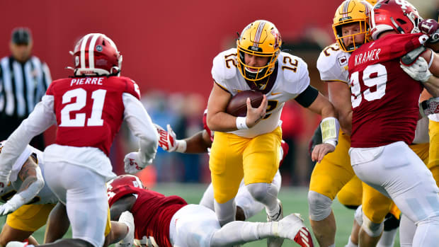 Nov 20, 2021; Bloomington, Indiana, USA; Minnesota Golden Gophers quarterback Cole Kramer (12) finds a hole in the Indiana Hoosiers during the second quarter at Memorial Stadium. 