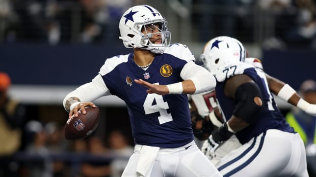 Dak Prescott winds up to throw a pass in the Cowboys’ Thanksgiving throwback jerseys