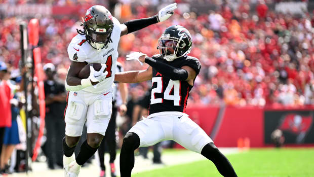 Oct 22, 2023; Tampa, Florida, USA; Tampa Bay Buccaneers running back Rachaad White (1) evades Atlanta Falcons defensive back A.J. Terrell (24) in the first half at Raymond James Stadium. Mandatory Credit: Jonathan Dyer-USA TODAY Sports  