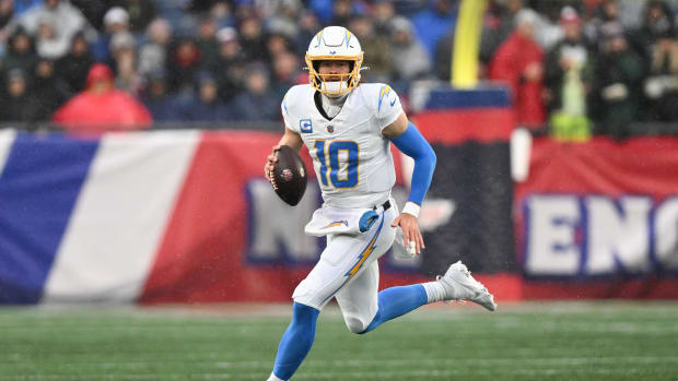 Dec 3, 2023; Foxborough, Massachusetts, USA; Los Angeles Chargers quarterback Justin Herbert (10) runs with the ball against the New England Patriots during the first half at Gillette Stadium. Mandatory Credit: Brian Fluharty-USA TODAY Sports  