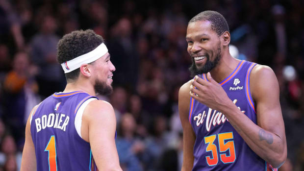 Phoenix Suns guard Devin Booker (1) and Phoenix Suns forward Kevin Durant (35) look on against the Portland Trail Blazers during the second half at Footprint Center.