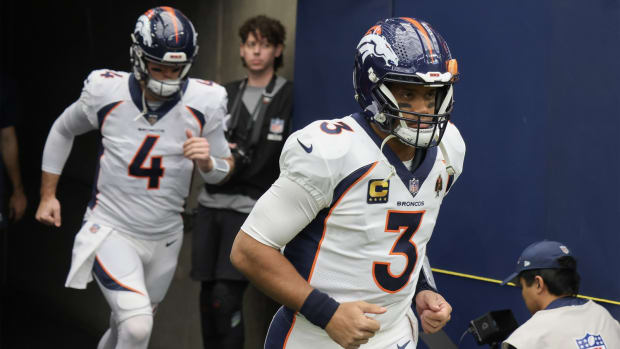 Denver Broncos quarterback Russell Wilson (3) and quarterback Jarrett Stidham (4) run out on the field before playing against the Houston Texans at NRG Stadium.