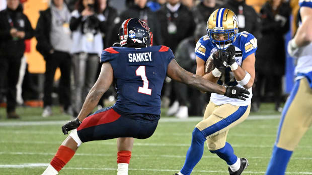 Nov 19, 2023; Hamilton, Ontario, CAN; Winnipeg Blue Bombers wide receiver Nic Demski (10) tries to elude a tackle from Montreal Alouettes defensive back Darnell Sankey (1) in the second half at Tim Hortons Field. Mandatory Credit: Dan Hamilton-USA TODAY Sports