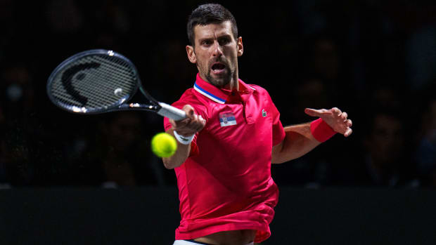 Novak Djokovic returns the ball against Jannik Sinner a Davis Cup semifinal.