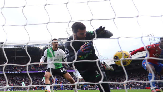 Liverpool goalkeeper Alisson Becker pictured making an impressive save during his team's 2-1 win at Crystal Palace in December 2023