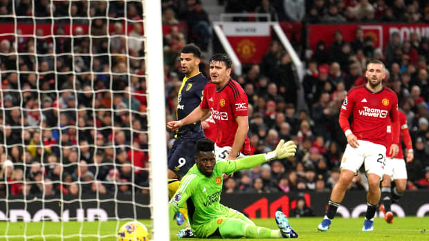 Manchester United's players pictured looking on helplessly as a fine shot from Bournemouth striker Dominic Solanke (no.9) rolls into the net during a Premier League game at Old Trafford in December 2023