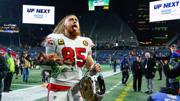 Nov 23, 2023; Seattle, Washington, USA; San Francisco 49ers tight end George Kittle (85) carries a roast turkey as he jogs to the locker room following a 31-13 victory against the Seattle Seahawks at Lumen Field. Mandatory Credit: Joe Nicholson-USA TODAY Sports  