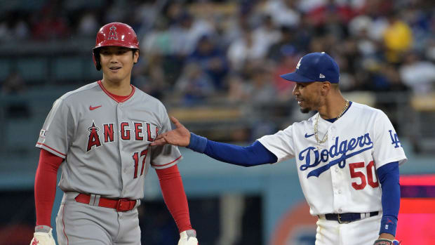 Former Los Angeles Angels pitcher Shohei Ohtani chats now-teammate Dodgers shortstop Mookie Betts after hitting a double (2023).