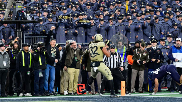 Dec 9, 2023; Foxborough, Massachusetts, USA; Army Black Knights running back Tyson Riley (32) scores a touchdown against the Navy Midshipmen during the first half at Gillette Stadium.