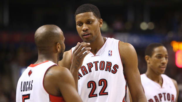 Feb 1, 2013; Toronto, ON, Canada; Toronto Raptors guard John Lucas (5) talks to forward Rudy Gay (22) as guard DeMar DeRozan (10) looks on against the Los Angeles Clippers at the Air Canada Centre. The Raptors beat the Clippers 98-73.