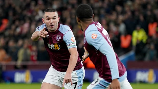 Aston Villa captain John McGinn pictured (left) celebrating after scoring the winning goal in a 1-0 victory over Arsenal in December 2023