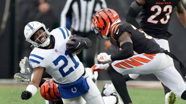 Cincinnati Bengals defensive tackle BJ Hill (92) brings down Indianapolis Colts running back Zack Moss (21) on Sunday, Dec. 10, 2023, during a game against the Cincinnati Bengals at Paycor Stadium in Cincinnati.