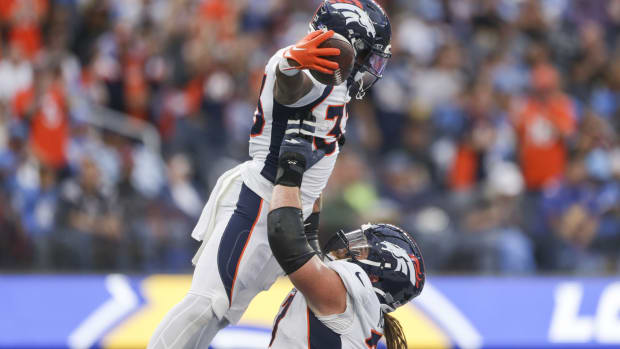 Denver Broncos running back Javonte Williams (33) celebrates with Denver Broncos guard Quinn Meinerz (77) during the first half in a game against the Los Angeles Chargers at SoFi Stadium