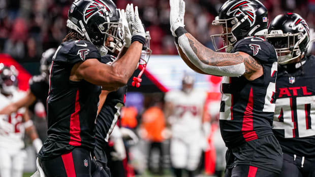 Atlanta Falcons running back Bijan Robinson (7) reacts with running back Tyler Allgeier (25) after running for a touchdown against the Tampa Bay Buccaneers during the second half at Mercedes-Benz Stadium.