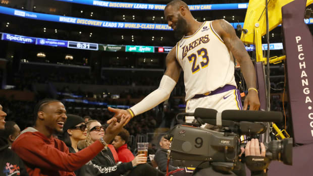 Nov 19, 2023; Los Angeles, California, USA; Los Angeles Lakers forward LeBron James (23) shakes hands with his son Bronny James during the second half against the Houston Rockets at Crypto.com Arena. Mandatory Credit: Kiyoshi Mio-USA TODAY Sports  
