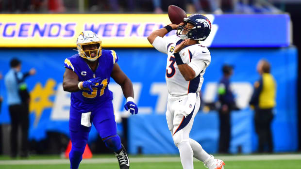 Denver Broncos quarterback Russell Wilson (3) throws a touchdown pass to wide receiver Courtland Sutton (14) against Los Angeles Chargers linebacker Nick Niemann (31) during the second half at SoFi Stadium.