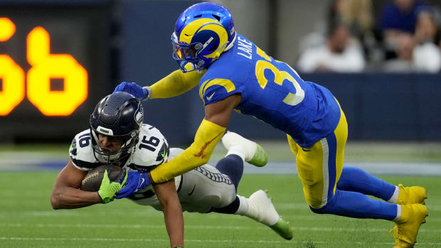 Los Angeles Rams safety Quentin Lake (37) tackles Seattle Seahawks wide receiver Tyler Lockett (16) in the third quarter at SoFi Stadium.