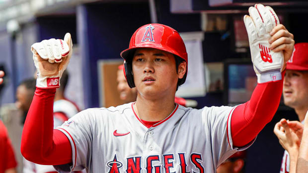 Angels’ Shohei Ohtani high-fives teammates in dugout