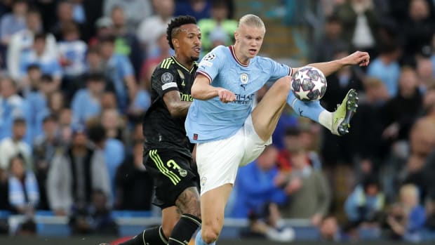 Erling Haaland pictured (right) shielding the ball from Eder Militao during a UEFA Champions League semi-final between Manchester City and Real Madrid in May 2023