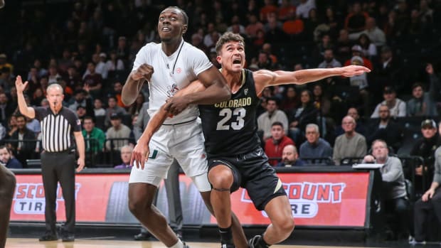 Dec 10, 2023; Brooklyn, New York, USA; Miami (Fl) Hurricanes center Michael Nwoko (1) and Colorado Buffaloes forward Tristan da Silva (23) box out for a rebound in the first half at Barclays Center
