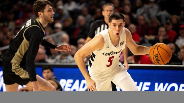 Cincinnati Bearcats guard CJ Fredrick (5) drives passed Bryant Bulldogs forward Connor Withers (7) in the first half of the NCAA Basketball game between the Bryant Bulldogs and Cincinnati Bearcats at Fifth Third Arena in Cincinnati on Tuesday, Dec. 12, 2023.  