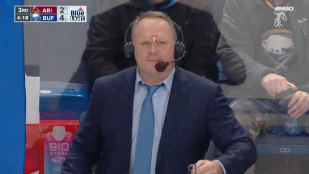 Sabres announcer Rob Ray with a makeshift bandage to stop bleeding on his head