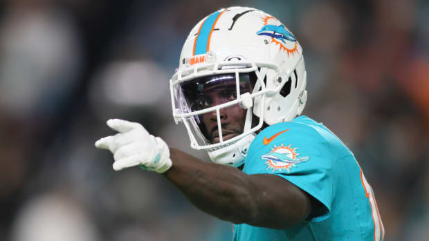Dolphins receiver Tyreek Hill signals to the team during a game.