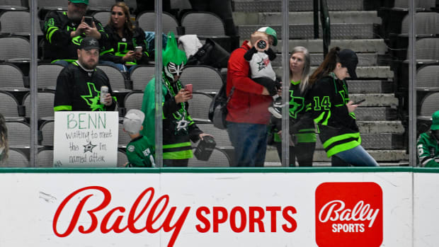A view of the Bally Sports logo and a Dallas Stars fan with a sign for left wing Jamie Benn before a game in April between the Stars and Vegas Golden Knights at the American Airlines Center.