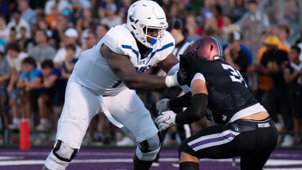 IMG's Jordan Seaton (77) holds off Lipscomb's Beck Woodside (35) at Lipscomb's Reese Smith Football Field in Nashville, Tenn., Friday night, Aug. 18, 2023.
