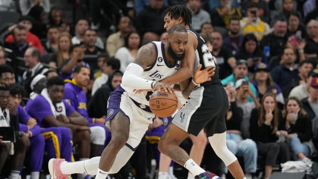 Nov 26, 2022; San Antonio, Texas, USA; Los Angeles Lakers forward LeBron James (6) dribbles in against San Antonio Spurs guard Devin Vassell (24) in the second half at the AT&T Center.