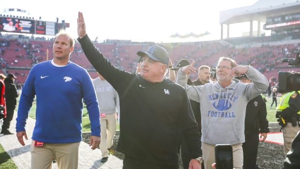 Kentucky coach Mark Stoops waves to fans after the Wildcats defeated Louisville at Kroger Field, Saturday, Nov. 25, 2023.