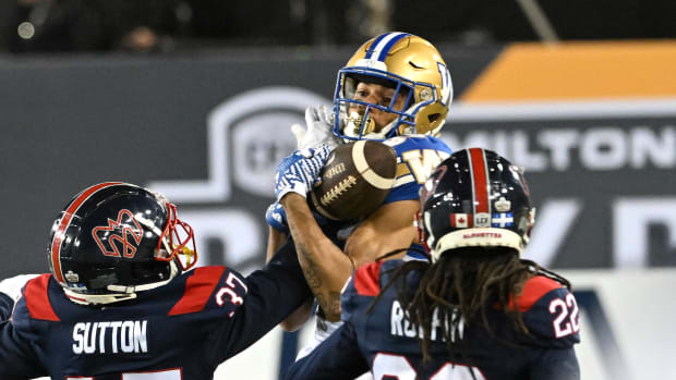 Nov 19, 2023; Hamilton, Ontario, CAN; Winnipeg Blue Bombers wide receiver Kenny Lawler (89) catches a pass over Montreal Alouettes defensive backs Dionte Ruffin (22) and Wesley Sutton (37) in the first half at Tim Hortons Field. Mandatory Credit: Dan Hamilton-USA TODAY Sports  
