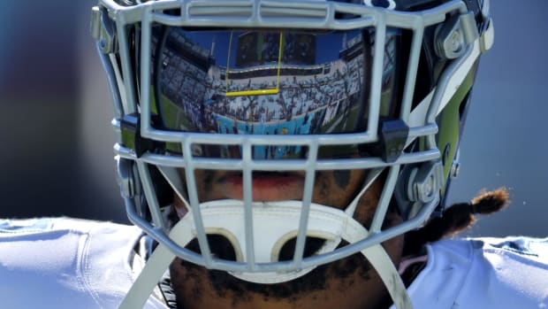 The north end zone stands reflect in the face shield of Tennessee Titans running back Derrick Henry (22) as he warmed up before the start of a game agains the Jacksonville Jaguars on November 19, 2023.