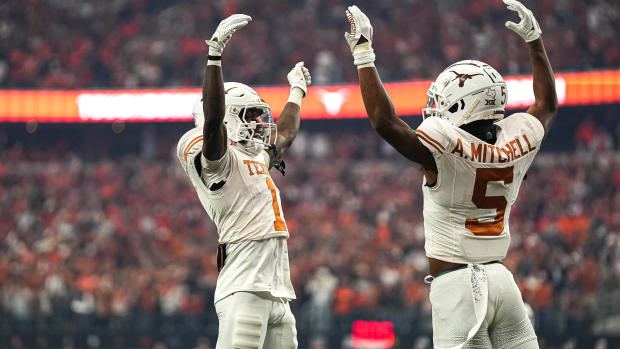 Texas Longhorns wide receivers Adonai Mitchell (5) and Xavier Worthy (1) celebrate a touchdown by Mitchell during the Big 12 Championship game against the Oklahoma State Cowboys at AT&T stadium on Saturday, Dec. 2, 2023 in Arlington.