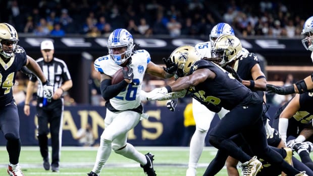 Dec 3, 2023; New Orleans, Louisiana, USA; Detroit Lions running back Jahmyr Gibbs (26) rushes against New Orleans Saints defensive end Carl Granderson (96) during the second half at the Caesars Superdome.