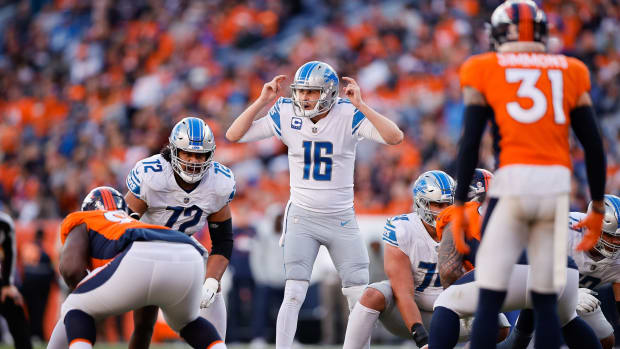 Detroit Lions quarterback Jared Goff (16) gestures at the line of scrimmage with guard Halapoulivaati Vaitai (72) as Denver Broncos safety Justin Simmons (31) looks on in the second quarter at Empower Field at Mile High.