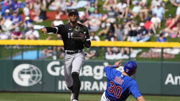 Mar 10, 2023; Mesa, Arizona, USA; Chicago White Sox shortstop Erik Gonzalez (15) makes the out on Chicago Cubs third baseman Edwin Rios (30) in the second inning at Sloan Park. Mandatory Credit: Rick Scuteri-USA TODAY Sports  