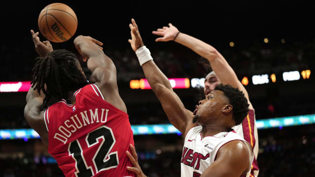 Miami Heat guard Kyle Lowry (7) forces Chicago Bulls guard Ayo Dosunmu (12) to alter his shot during the first half at Kaseya Center.
