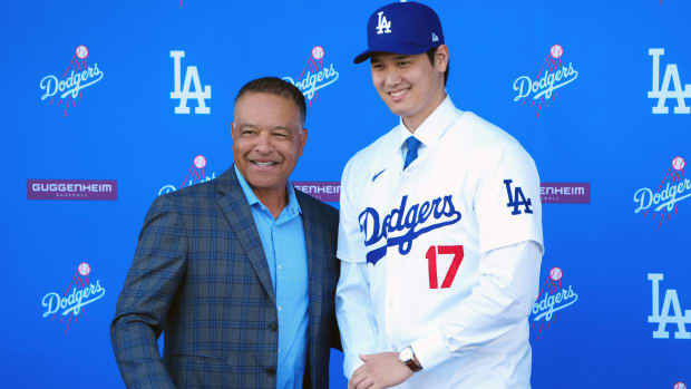 Dodgers star Shohei Ohtani and manager Dave Roberts take a picture at a press conference.