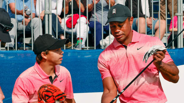 Dec 17, 2022; Orlando, Florida, USA; Charlie Woods and his father Tiger Woods (right) talk on the first tee during the first round of the PNC Championship golf tournament at Ritz Carlton Golf Club Grande Lakes Orlando Course. Mandatory Credit: Reinhold Matay-USA TODAY Sports