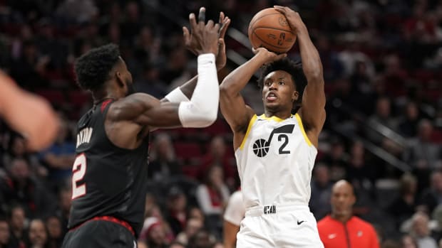 Utah Jazz point guard Collin Sexton (2) shoots the ball over Portland Trail Blazers center Deandre Anton (2) during the first half at Moda Center.