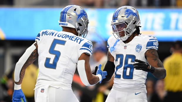 Detroit Lions running back Jahmyr Gibbs (26) celebrates with running back David Montgomery (5) after scoring a touchdown against the Los Angeles Chargers during the first half at SoFi Stadium.