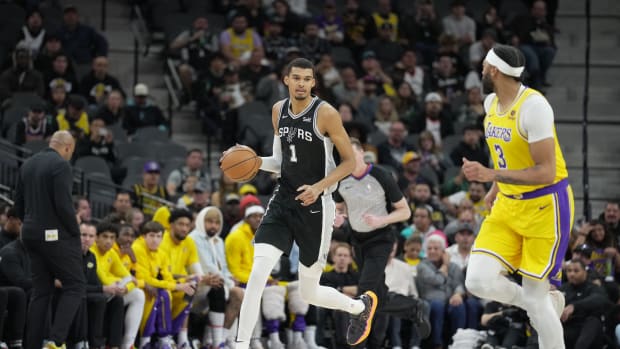 Dec 13, 2023; San Antonio, Texas, USA; San Antonio Spurs center Victor Wembanyama (1) dribbles the ball in front of Los Angeles Lakers forward Anthony Davis (3) in the first quarter at the Frost Bank Center.