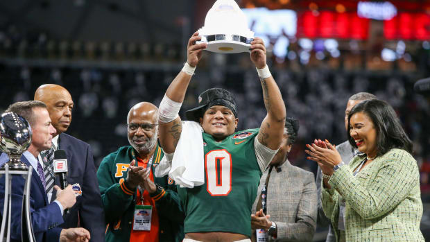 Florida A&M linebacker Isaiah Major holds the Celebration Bowl defensive MVP trophy aloft after the Rattlers' 30-26 win over Howard on Dec. 16, 2023.